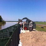 ASSUMPTION PARISH, La.  Louisiana National Guardsmen with the 256th Brigade Special Troops Battalion instruct inmates and demonstrate the proper way to construct sand-filled HESCO barriers in an effort to prevent possible backwater flooding in Assumption Parish, La., following the opening of the Morganza Spillway, May 18, 2011. (Courtesy photo by the 256th Brigade Special Troops Battalion, Louisiana National Guard/Released)